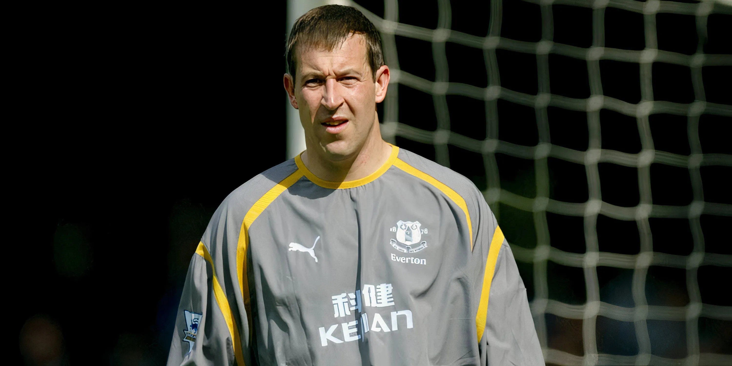 Thủ môn Nigel Martyn của Everton đang chỉ đạo hàng phòng ngự, thể hiện sự tập trung và khả năng tổ chức của mình.